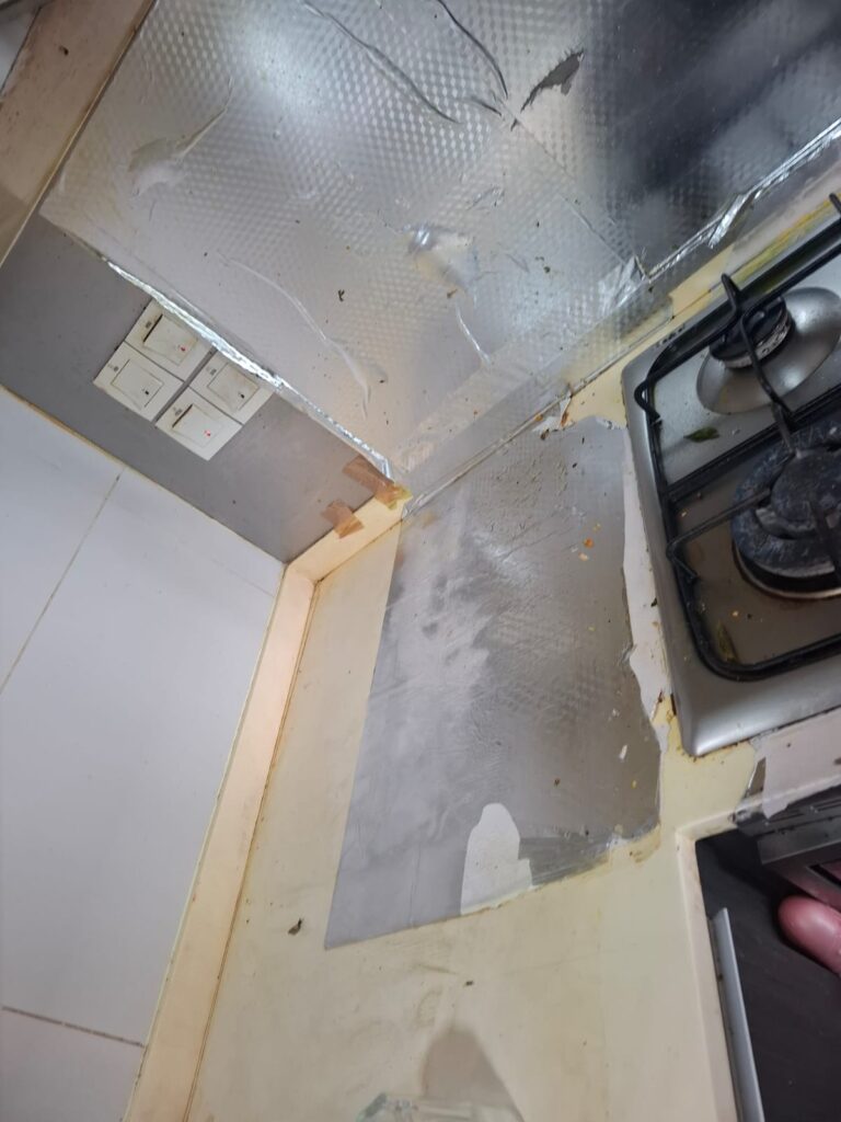 Sticky oil protector films behind stoves